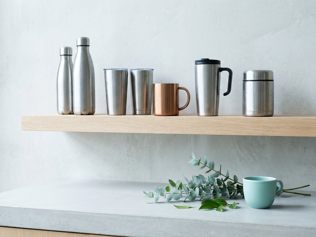 A styled shelf of stainless hydration gear